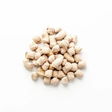 Pile of small, round, beige pet treats on a white background