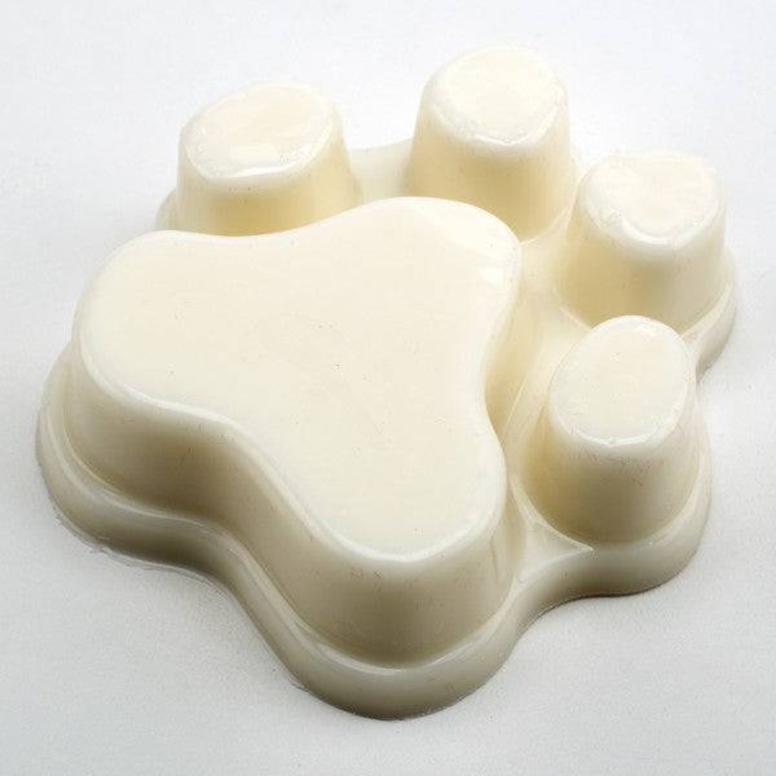 Beige silicone mold with heart and round cavities on a white background