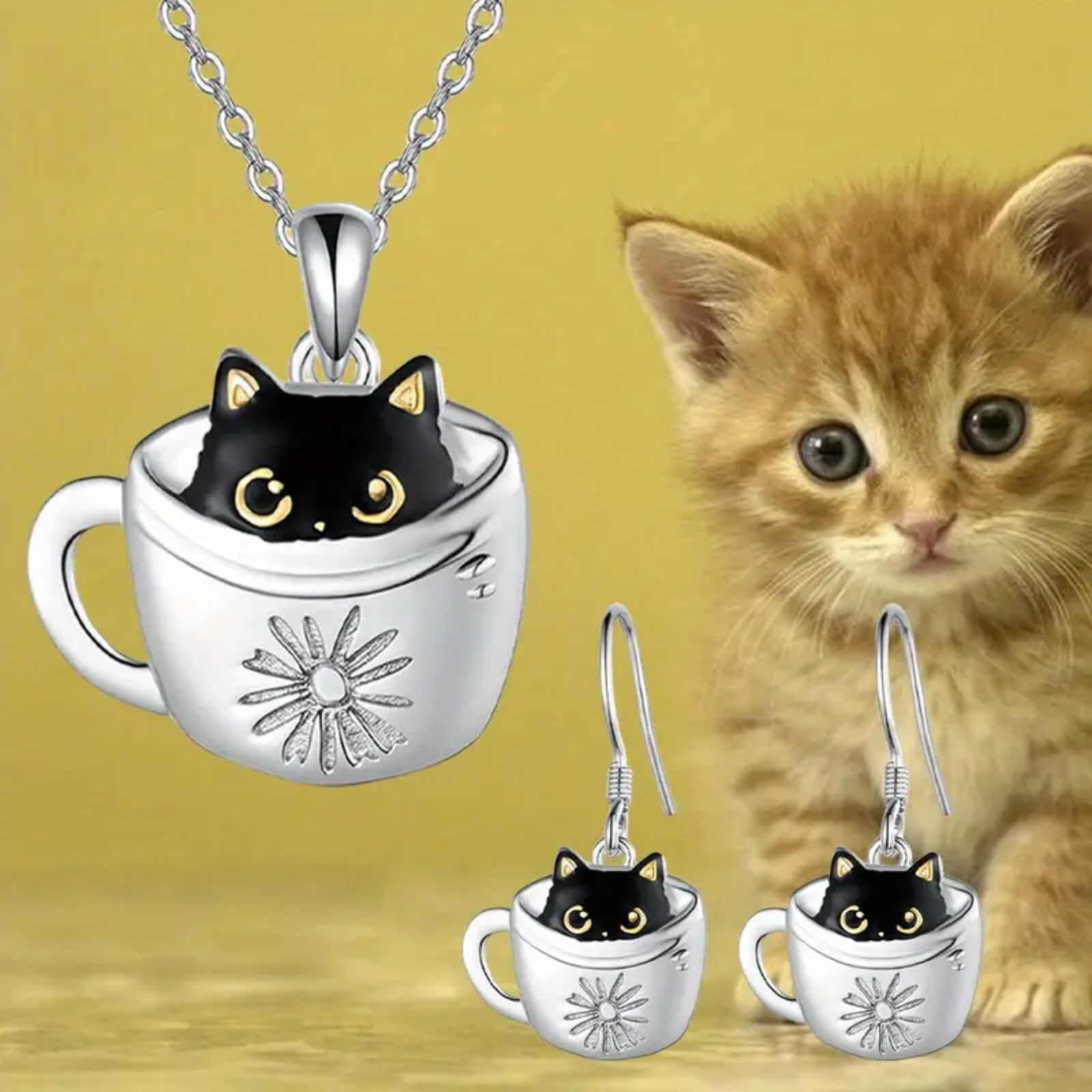 Cat-themed jewelry set with necklace and earrings next to a kitten on a yellow background