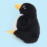 Plush penguin toy on a light blue background