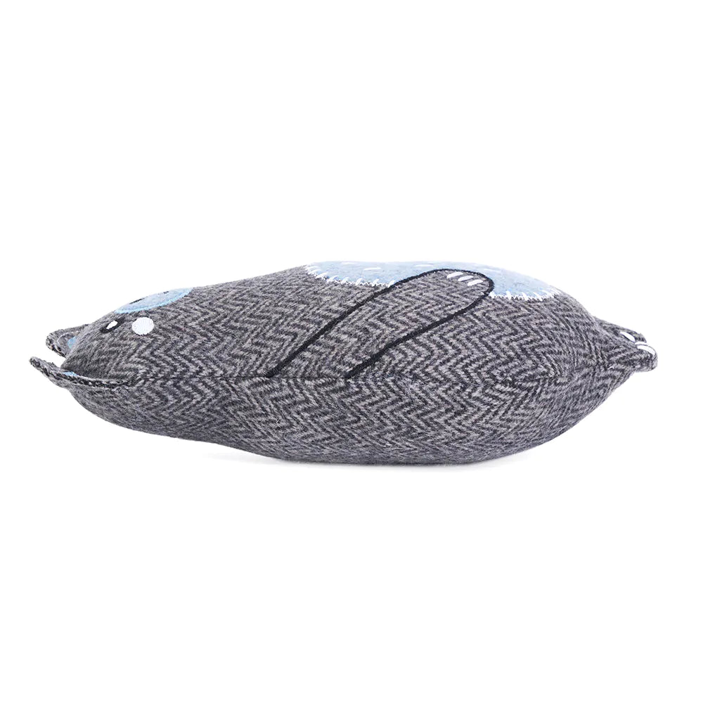Textured fish-shaped pillow with a zigzag pattern on a white background