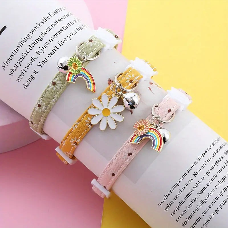 Three colorful bracelets with charms on an open book