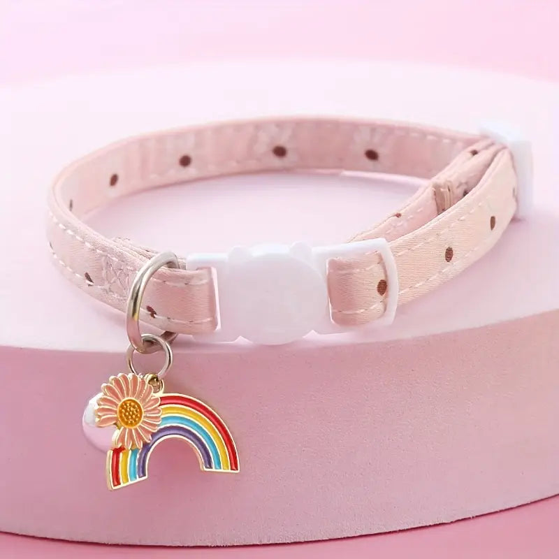 Pink pet collar with a rainbow and flower charm on a pink background