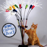 A cat playing with a feather bouncer toy, which has a wand with colorful feathers and a cable for bounce.