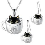 Cat-themed jewelry set with necklace, earrings, and cup-shaped pendants on a white background