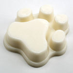 Beige silicone mold with heart and round cavities on a white background