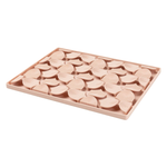 Pink silicone mold with wave patterns on a white background