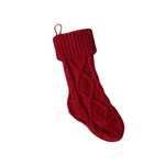 Red knitted Christmas stocking on a white background