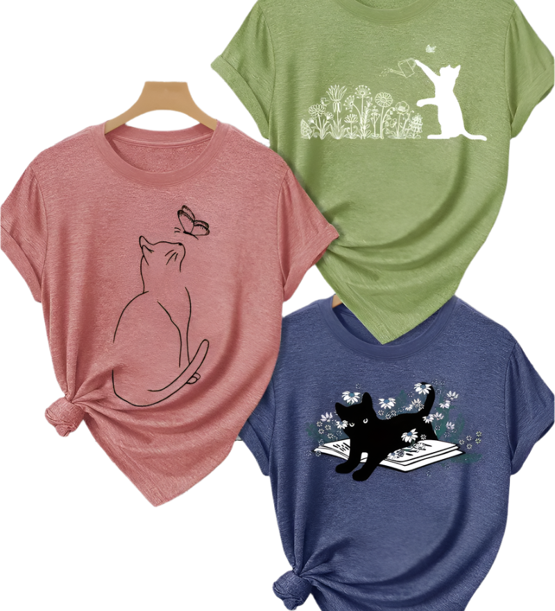 Three t-shirts with cat designs on a white background