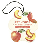 Car air freshener with mango peach design on a white background
