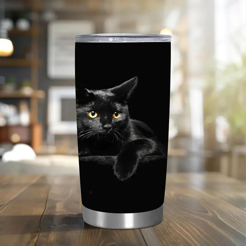 Tumbler with a black cat design on a wooden table