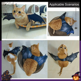 Cat wearing a bat costume in various poses on a tiled floor.