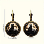 Pair of earrings with black cat design on a white background