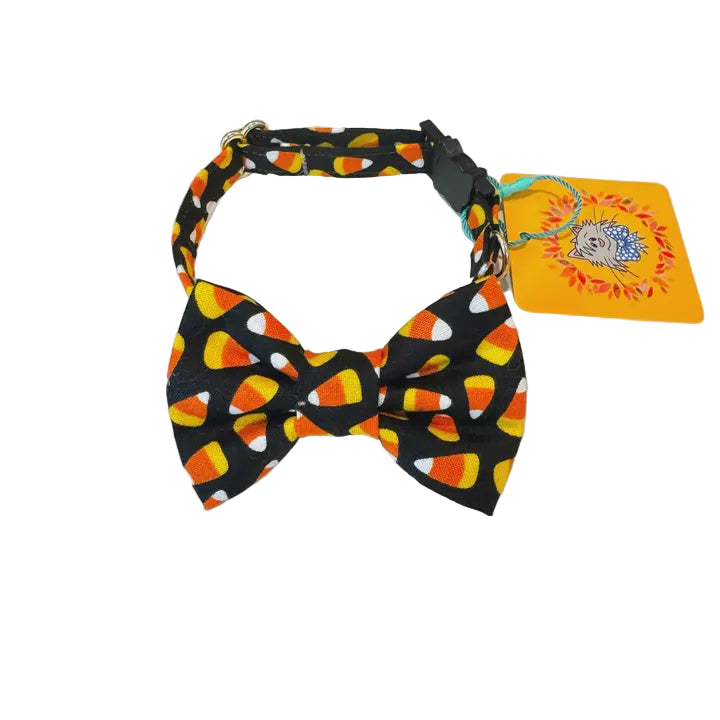 Dog collar with candy corn pattern and matching bow tie on a white background