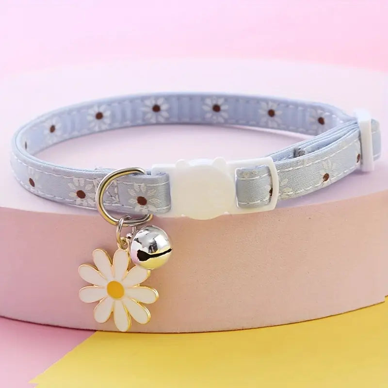 Cat collar with daisy flower charm and bell on a colorful background