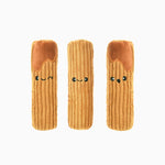 Three plush toys shaped like pasta with smiling faces on a white background