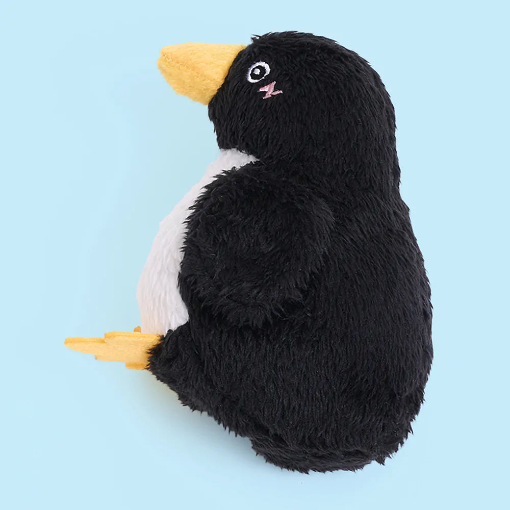 Plush penguin toy on a light blue background