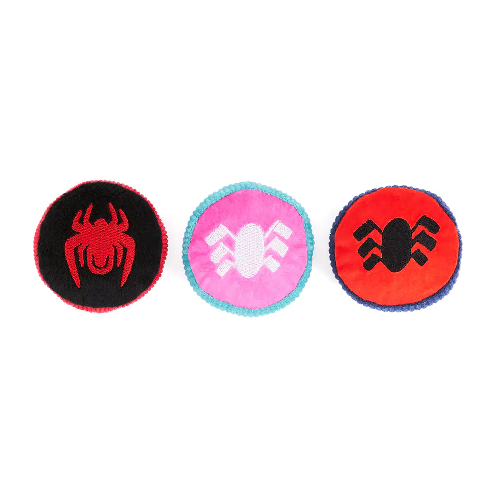 Three round toys with spider designs on a white background