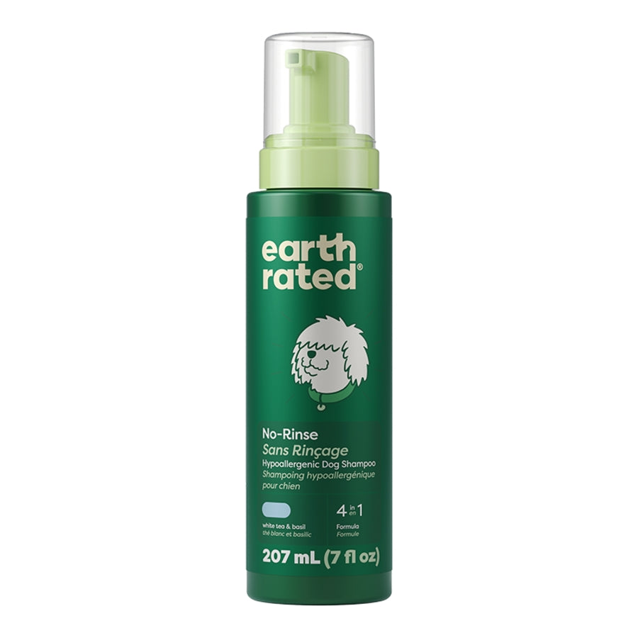 Green bottle of Earth Rated no-rinse dog shampoo on a white background