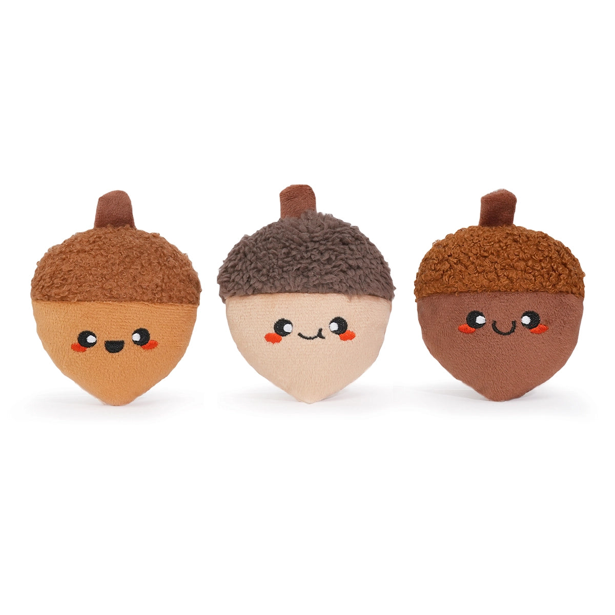 Three cute acorn-shaped toys with faces on a white background