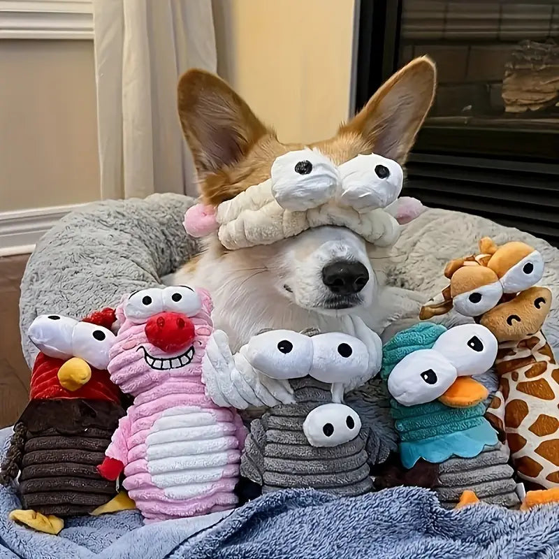 Corgi surrounded by plush toys on a soft surface