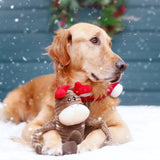 Dog wearing a reindeer costume with snow falling in the background